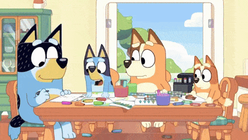 a group of cartoon dogs are sitting at a table with crayons on it .