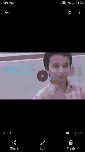 a phone screen shows a video of a boy giving a peace sign