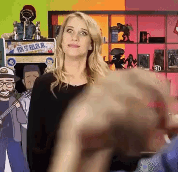 a woman stands in front of a poster that says fix it felix jr.