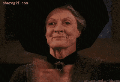 a woman in a hat is clapping her hands and smiling .