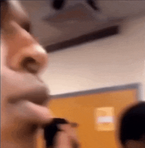 a blurry picture of a person 's face in a room with a door .