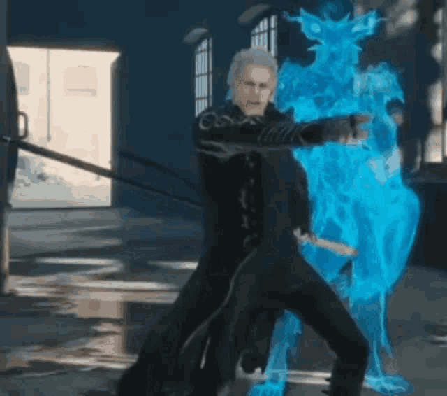 a man in a black suit is standing in front of a blue statue .