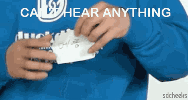 a person wearing a blue shirt that says can hear anything on it