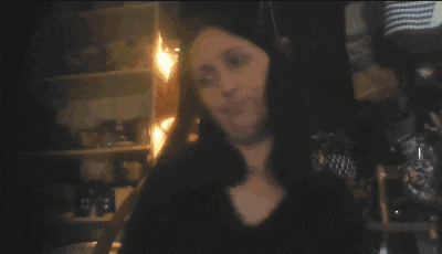 a blurry picture of a woman 's face with a fire in the background