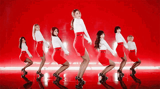 a group of women in red skirts and white tops are dancing on a red background