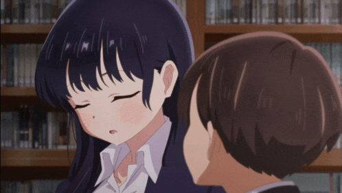 a girl with her eyes closed is standing next to a boy with his eyes closed