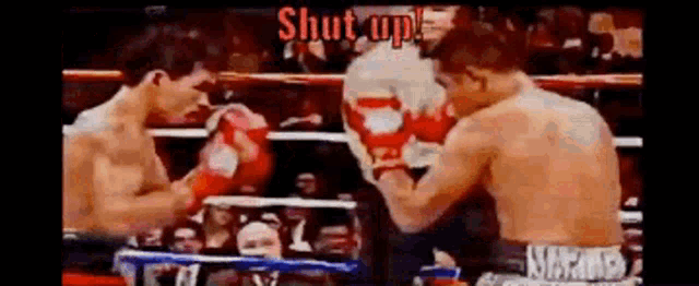 two men are boxing in a ring and the words shut up are visible