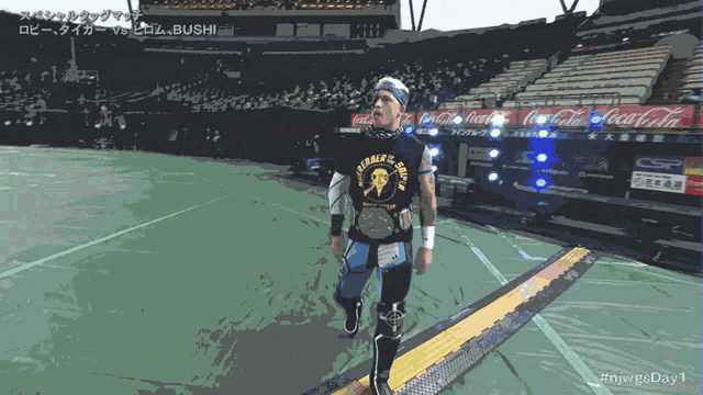 a man in a black shirt with the word tiger on it walks down stairs