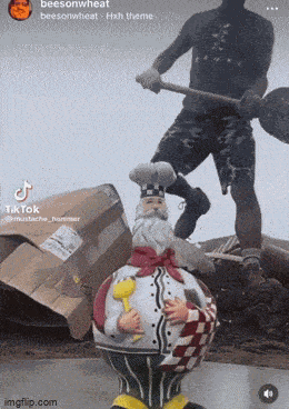 a statue of a chef in a chef 's hat is in front of a pile of cardboard boxes