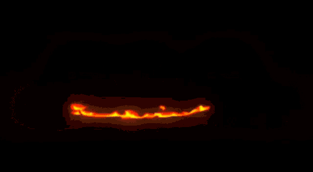 it looks like a cartoon fire coming out of a hole in the ground .