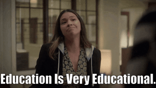 a woman says education is very educational while standing in front of a window