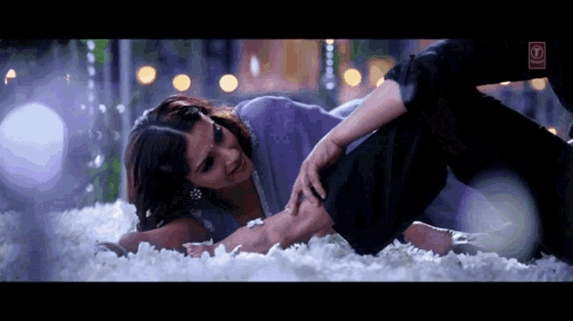 a woman is laying on a man 's lap with a label that says ' a ' on it