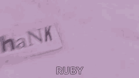 the word hank is being written on a pink surface .