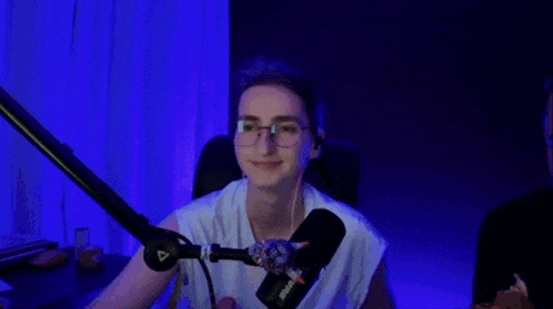 a close up of a person wearing glasses and earphones .