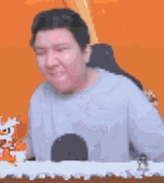 a blurry picture of a man sitting at a table with a microphone