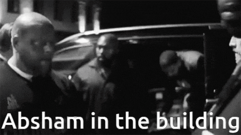 a black and white photo of a group of men with the caption absham in the building