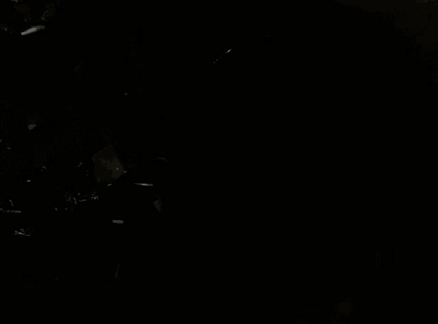 a dark room with a few lights coming out of the corner