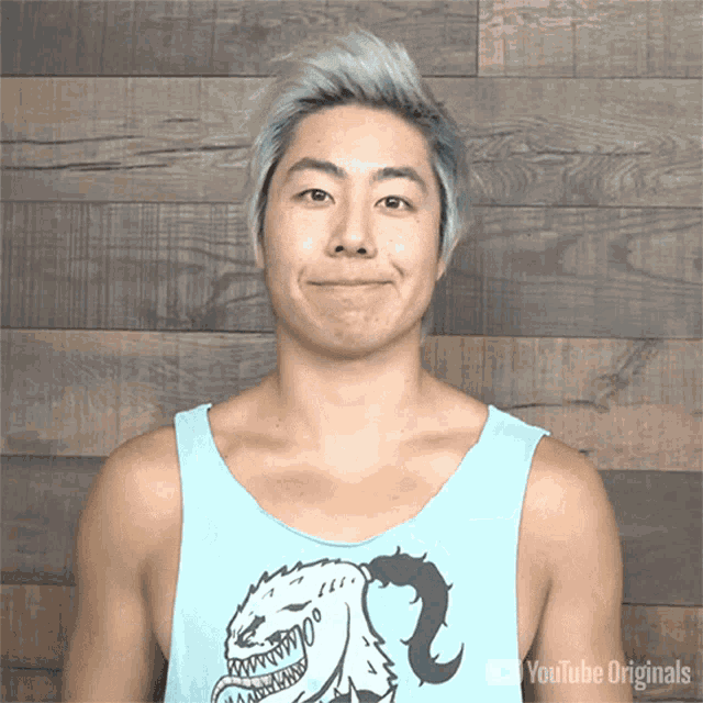 a man wearing a blue tank top that says youtube originals on the bottom