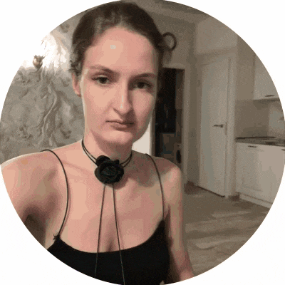 a woman wearing a black top and a black flower necklace
