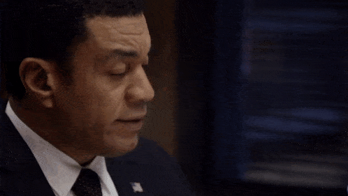 a man in a suit and tie with the words " who else knows about this " behind him