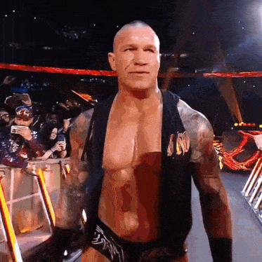 a wrestler wearing a black vest with the word n on it