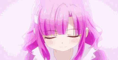 a close up of a girl with pink hair making a face .