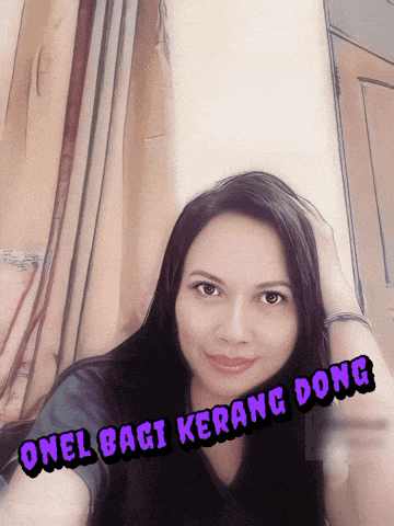 a woman taking a selfie with the words onel bagi karang dong written on her face