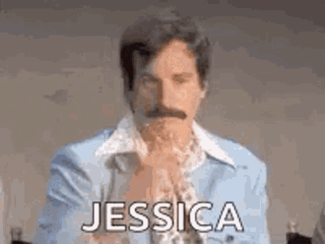 a man with a mustache is wearing a blue suit and a white shirt and is saying jessica .