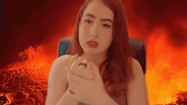 a woman with a ring on her finger looks at the camera