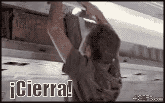 a man is hanging upside down on a ceiling with the words i cierra ! written above him .