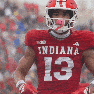 a football player wearing a red indiana jersey with the number 13 on it
