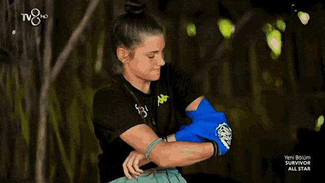 a woman wearing a black t-shirt with the number 83 on it