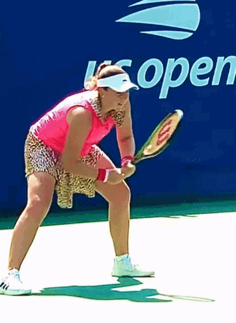 a woman is holding a tennis racquet in front of an open sign