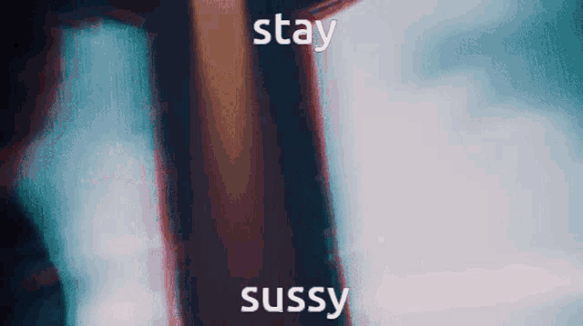 a blurry picture of a person standing next to a door with the words `` stay sussy '' written on it .