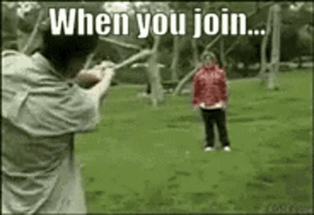 a man is holding a stick in front of a woman in a red jacket and says when you join ..