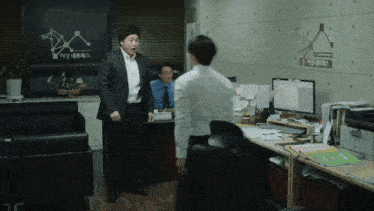 a man in a suit stands in front of a sign that says ' korean '
