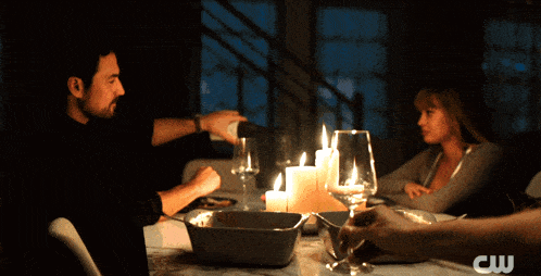 a man pouring wine into a glass with the cw logo in the corner