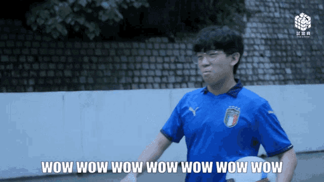 a man wearing a blue shirt with the word wow on it