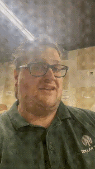 a man wearing glasses and a green shirt that says dollar tree on it