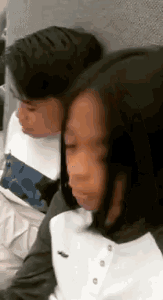 a boy and a girl are sitting next to each other .