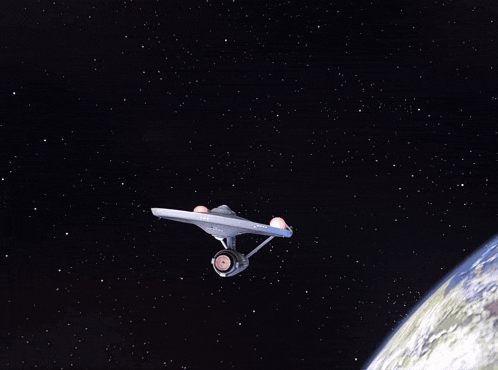 a white space ship is flying over a planet in space