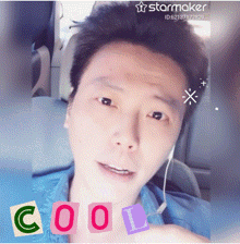 a man is wearing headphones and has the word cool written on his face