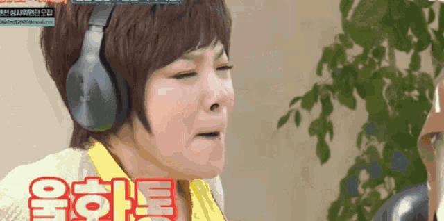 a woman wearing headphones is making a funny face in a video