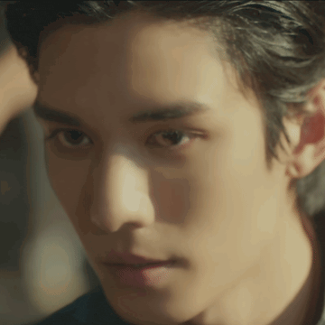 a close up of a man 's face with a shadow on his forehead