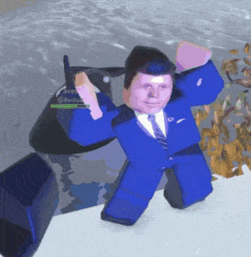 a man in a blue suit and tie is standing in front of a jet ski with the name avilia on it