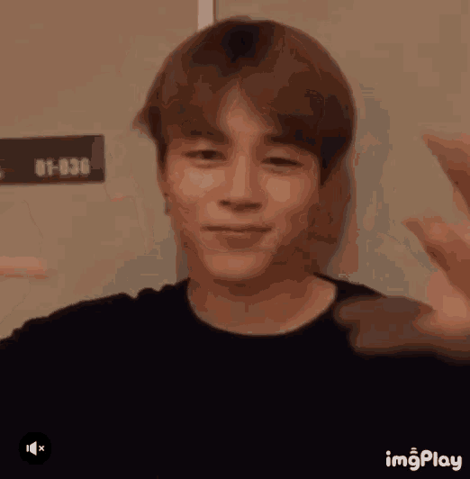 a close up of a person making a funny face with their hands