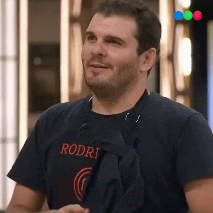 a man wearing a black rodri t-shirt is smiling
