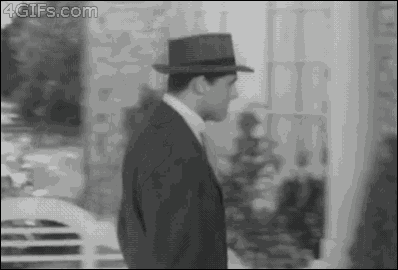 a black and white photo of a man wearing a hat with the website 4gifs.com in the upper right corner