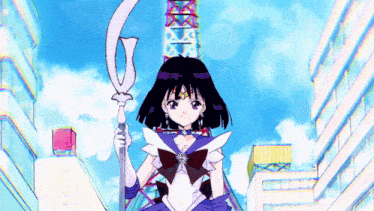 a girl in a sailor moon outfit is holding a sword in front of a tower .