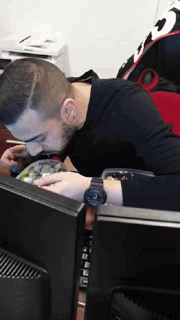 a man wearing a casio watch is eating a salad